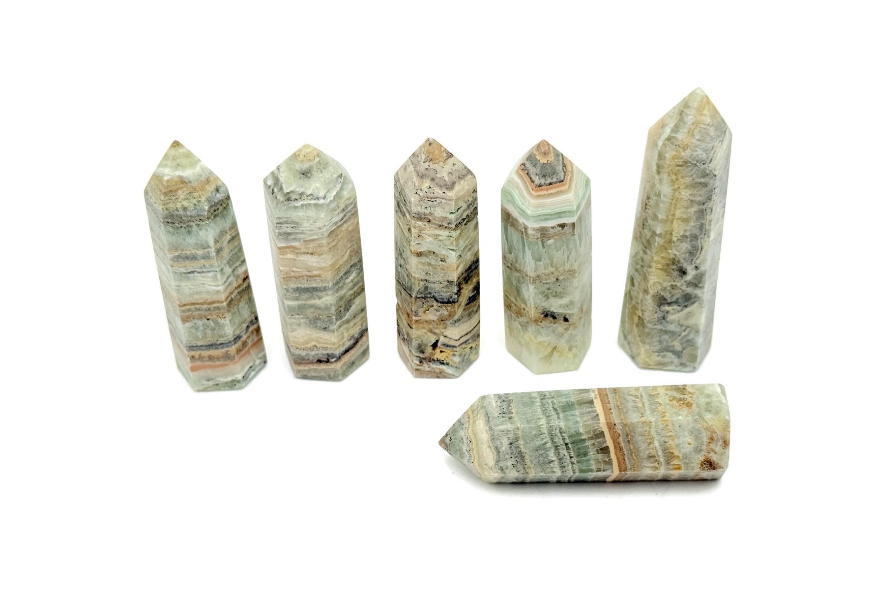 Caribbean Green Calcite obelisk tower crystal from GemstoneGO, showcasing a vibrant green mineral with smooth polished surfaces.