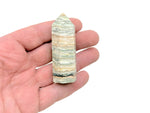 Caribbean Green Calcite obelisk tower crystal by GemstoneGO, showing a polished green stone with natural patterns and a pointed top.