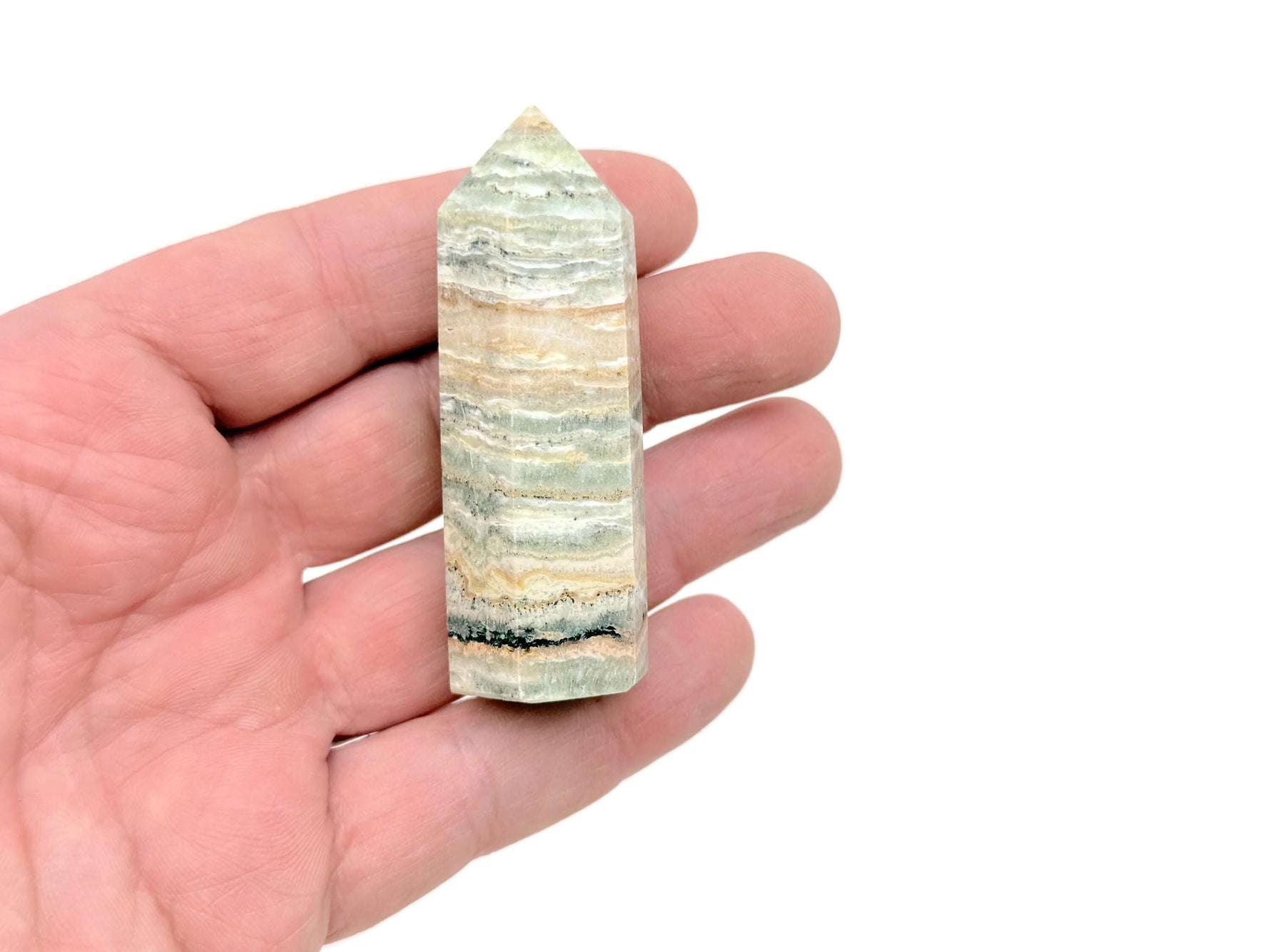 Caribbean Green Calcite obelisk tower crystal by GemstoneGO, showing a polished green stone with natural patterns and a pointed top.