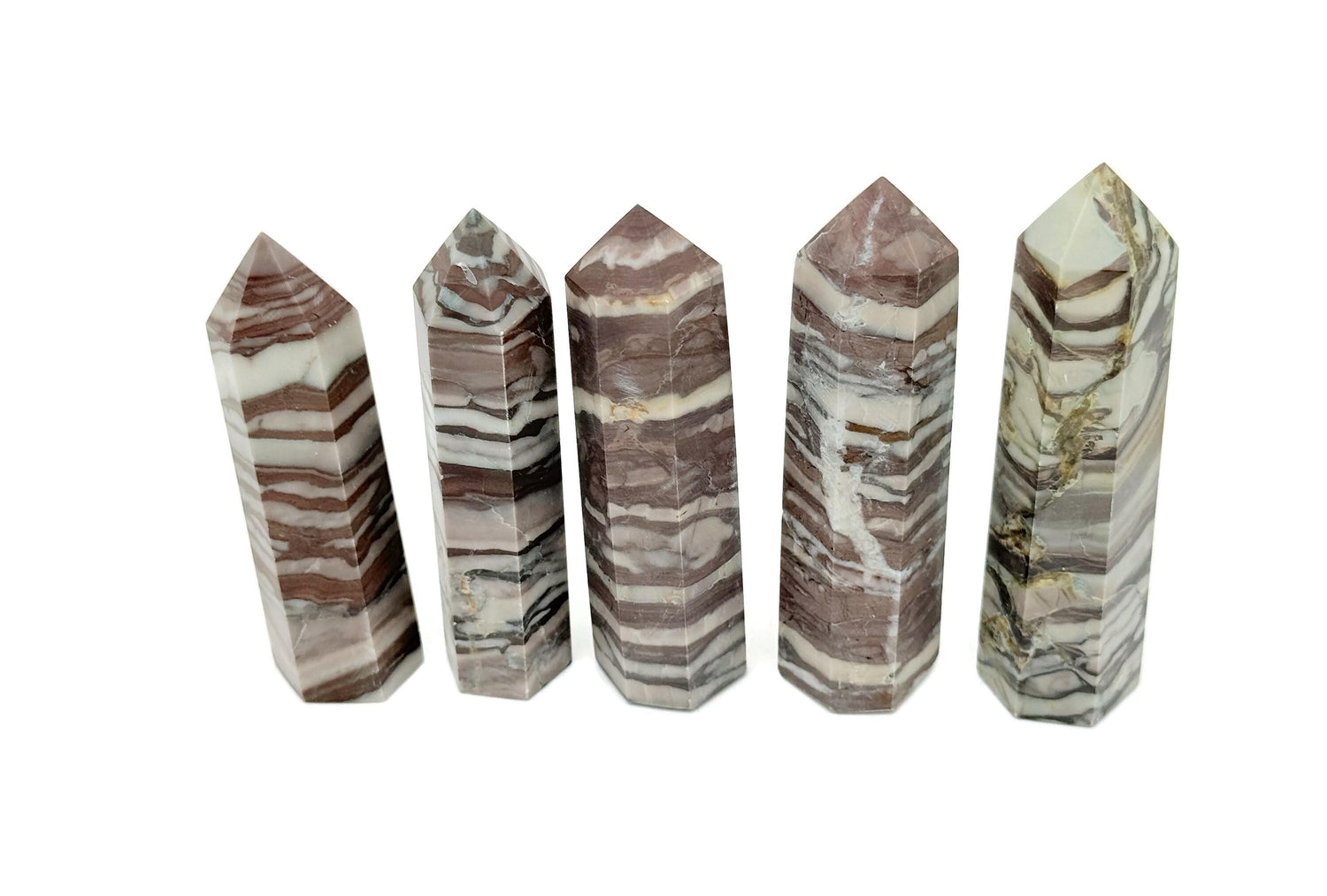 Red Zebra Calcite obelisk tower crystal from GemstoneGO, showcasing vibrant red and black striped mineral formations.