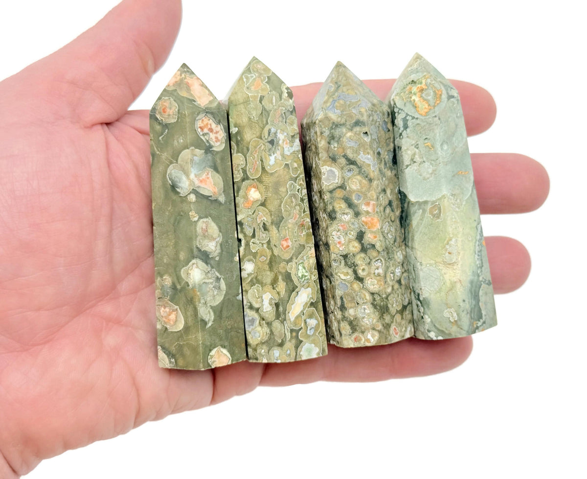Rhyolite Obelisk Tower crystal from GemstoneGO featuring vibrant rainforest green hues and natural stone textures.