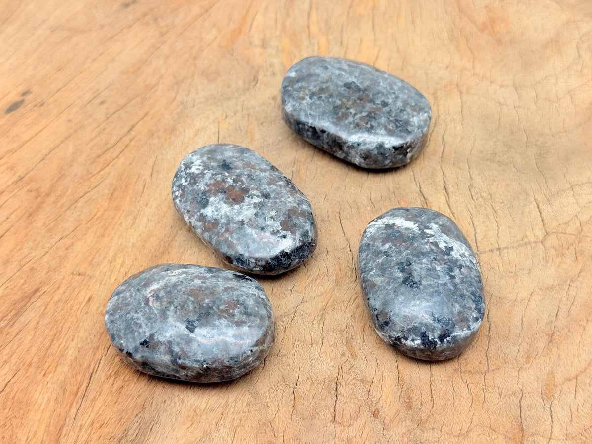 Yooperlite Palm Gemstone with fluorescent sodalite, spa stone from GemstoneGO, showcasing glowing blue and white mineral patterns.