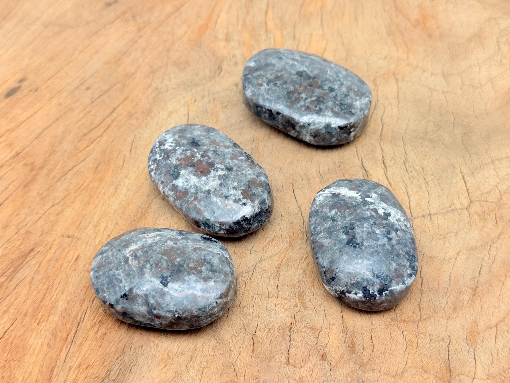Yooperlite Palm Gemstone with fluorescent sodalite, spa stone from GemstoneGO, showcasing glowing blue and white mineral patterns.