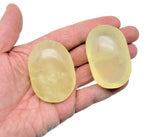 Citrine palm gemstone spa stone from GemstoneGO showing a polished yellow-orange citrine stone with smooth, rounded surface.