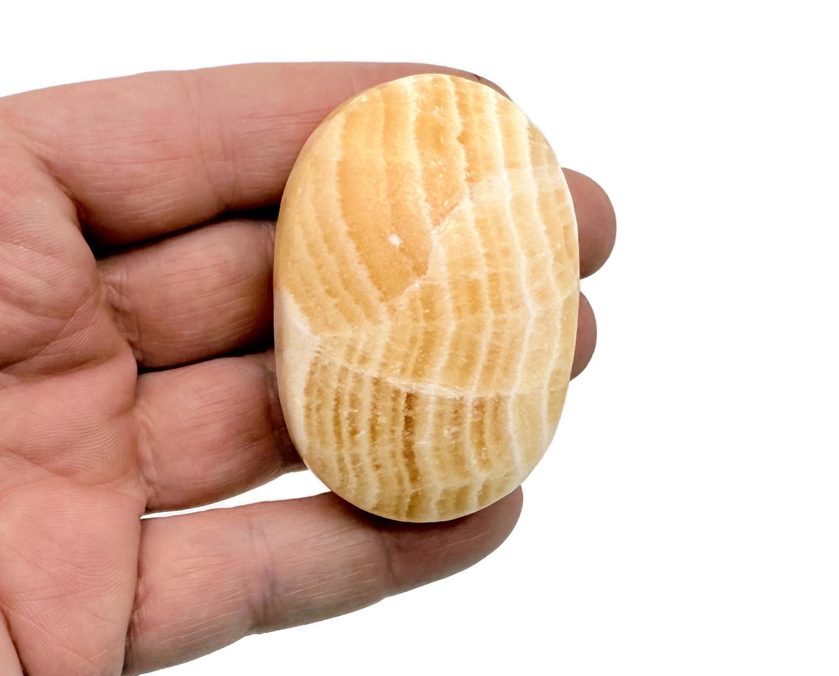 Yellow Calcite palm gemstone spa stone from GemstoneGO, showing a smooth, polished yellow calcite palm-sized healing gemstone.