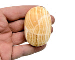 Yellow Calcite palm gemstone spa stone from GemstoneGO, showing a smooth, polished yellow calcite palm-sized healing gemstone.