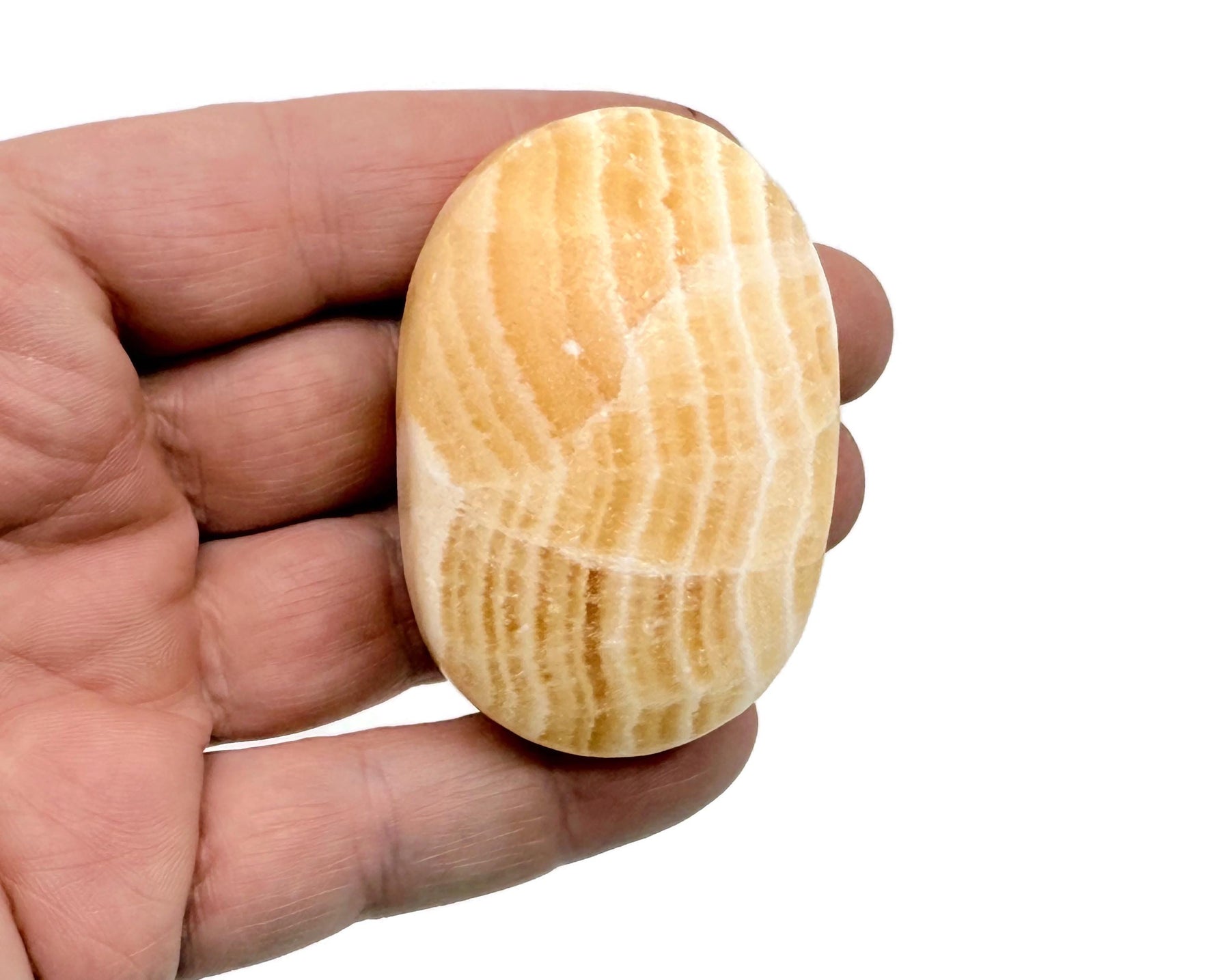 Yellow Calcite palm gemstone spa stone from GemstoneGO, showing a smooth, polished yellow calcite palm-sized healing gemstone.