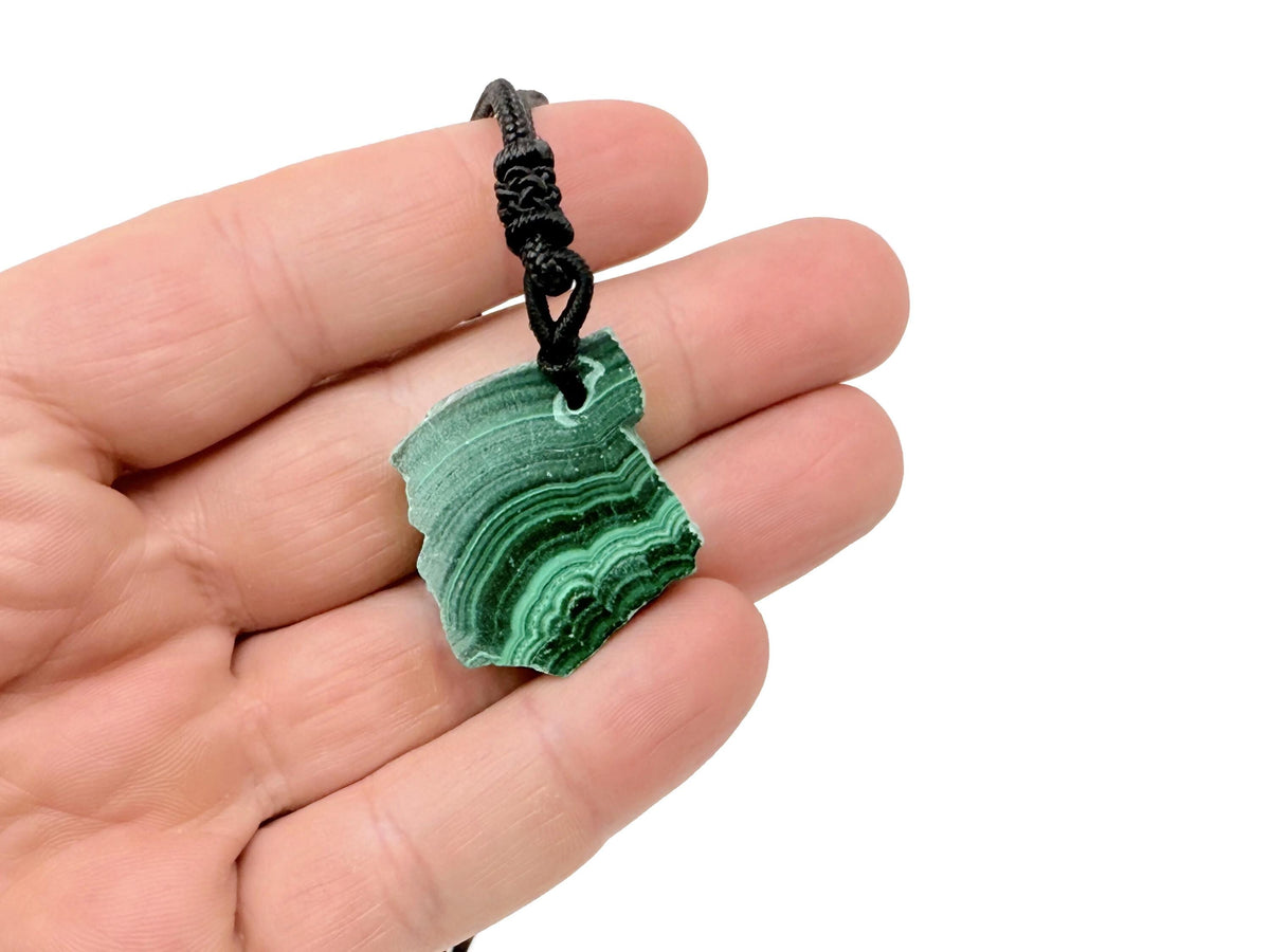 Malachite crystal necklace with adjustable cord from GemstoneGO, featuring a polished green gemstone pendant on a black cord.
