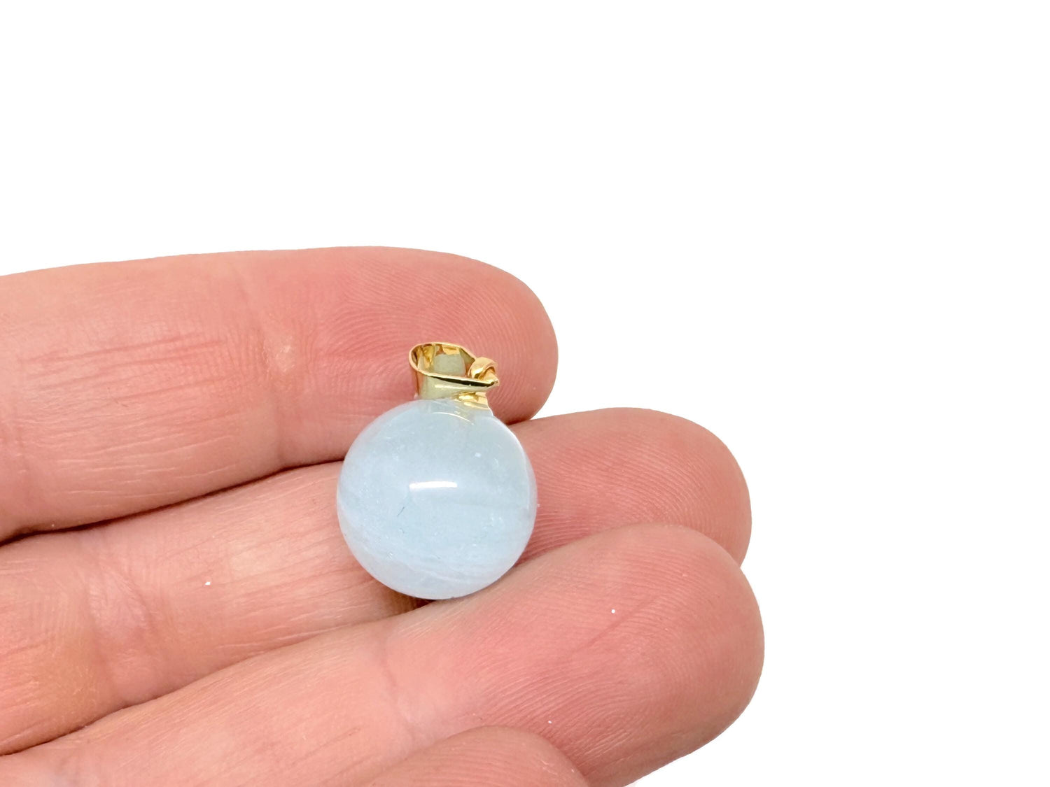 Aquamarine crystal pendant with polished round ball design, showcasing clear, calming blue gemstone for clarity and inner peace.