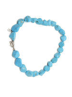 Turquoise jewelry set with crystal accents, including necklace and earrings, by GemstoneGO, showcasing vibrant turquoise stones and elegant design.