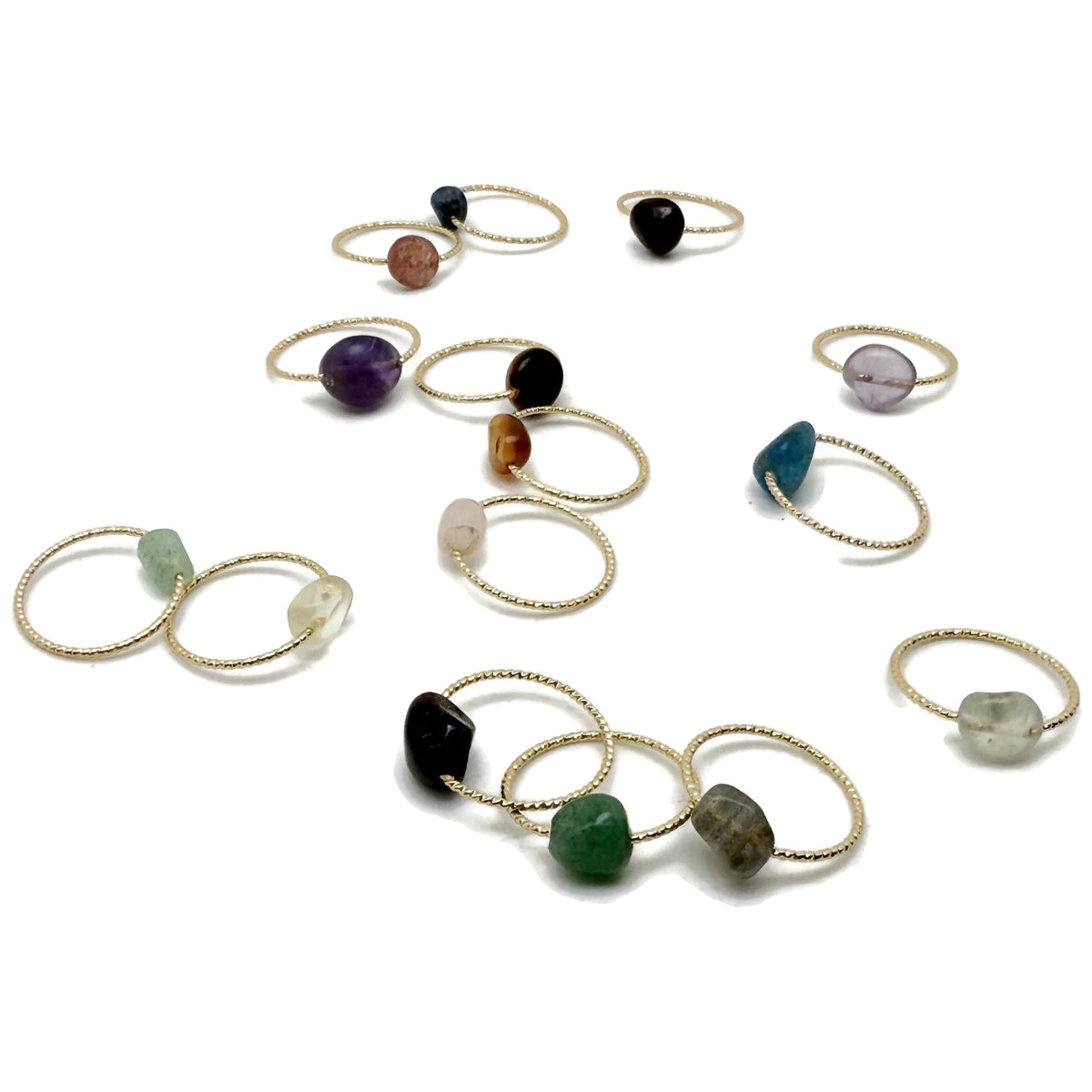 Dainty gemstone gold wire rings with natural crystal accents, showcasing a delicate jewelry design from GemstoneGO.