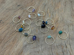 Dainty gemstone gold wire rings with natural crystal accents, showcasing delicate jewelry design by GemstoneGO.