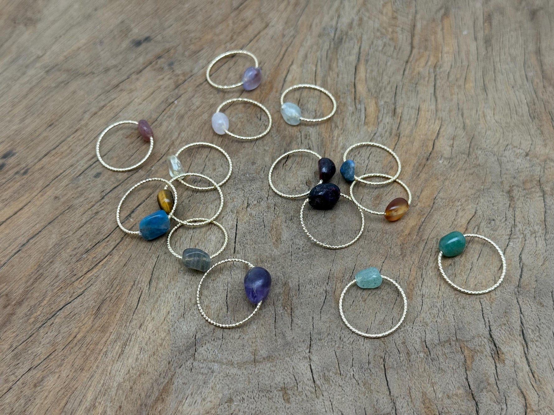 Dainty gemstone gold wire rings with natural crystal accents, showcasing delicate jewelry design by GemstoneGO.