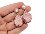 Rose quartz jewelry set from GemstoneGO featuring a necklace and earrings with pink crystal stones on a white background.