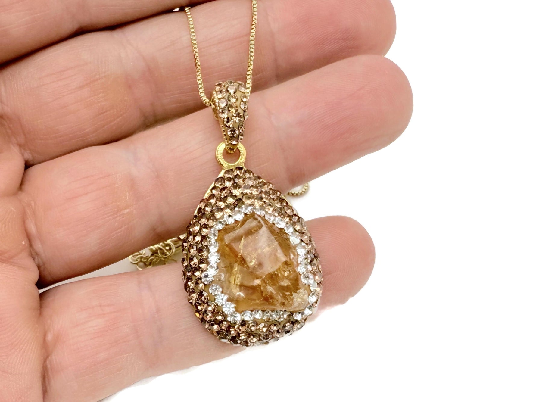 Citrine crystal jewelry set by GemstoneGO featuring a necklace and earrings with vibrant yellow-orange gemstones.