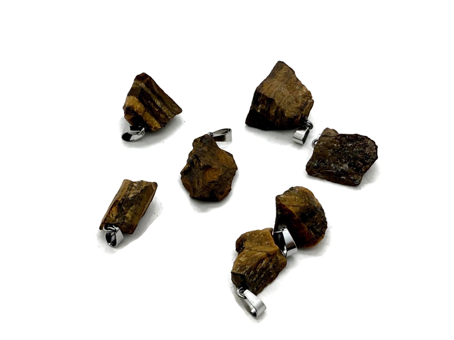 Tiger Eye crystal pendant from GemstoneGO, showcasing a polished, oval-shaped gemstone with a silver loop for jewelry making.
