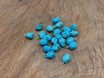 Turquoise crystal pendant with blue stones from GemstoneGO, showcasing a vibrant, polished gemstone necklace on a display stand.