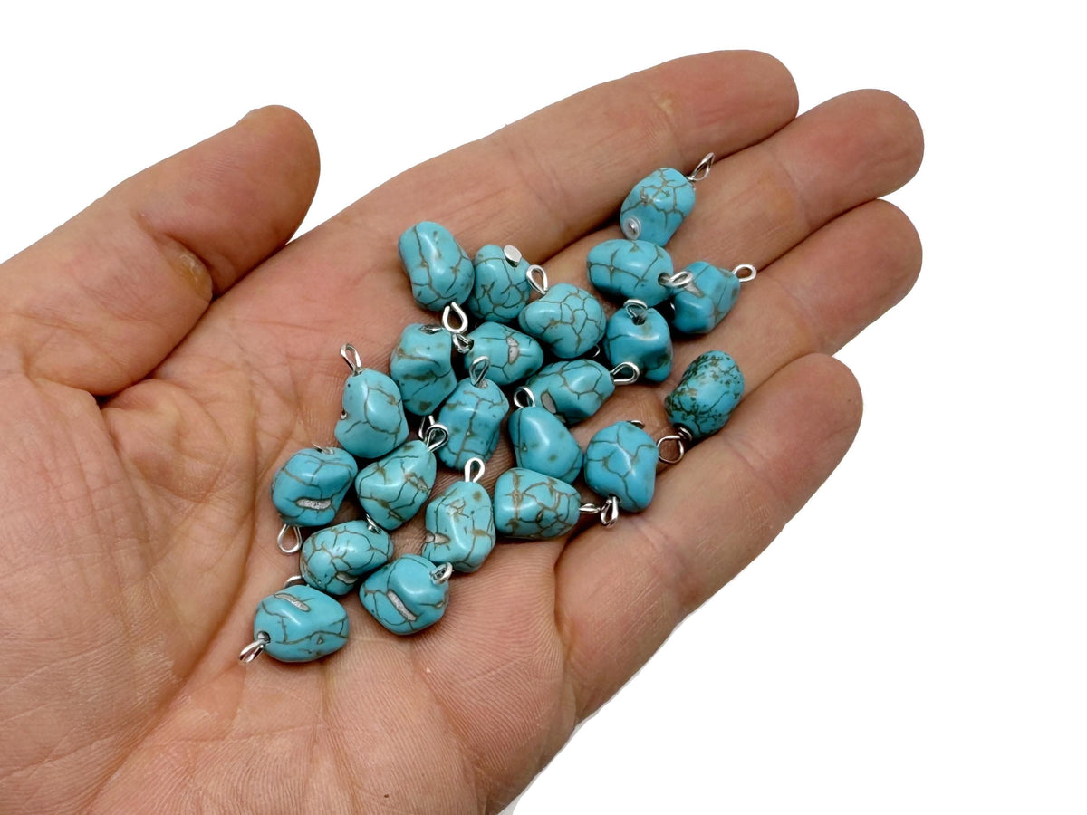Turquoise crystal pendant with blue stones from GemstoneGO, featuring a polished, dangling gemstone design on a silver chain.