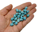 Turquoise crystal pendant with blue stones from GemstoneGO, featuring a polished, dangling gemstone design on a silver chain.