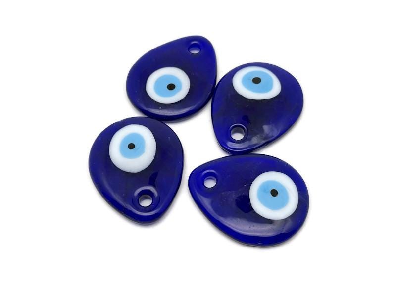 Blue glass evil eye charm with hole for hanging, Turkish Nazar decor by GemstoneGO, featuring a vibrant blue eye design.