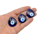 Drop Blue Glass Evil Eye charm with hole, Turkish Nazar symbol, blue glass bead, ideal for home decor or jewelry making.