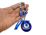 Blue glass evil eye charm with intricate design, Turkish Nazar charm used for protection and home decor, by GemstoneGO.