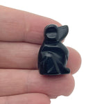 Handmade carved 30mm crystal dog animal figure by GemstoneGO with colorful mixed gemstones on a white background.