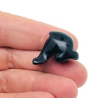 Handmade 30mm crystal dolphin animal figure by GemstoneGO, carved gemstone with vibrant colors on a plain background.