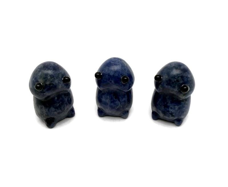 Handcrafted sodalite frog monster gemstone carving statue with detailed features, showcasing vibrant blue and white stone patterns.