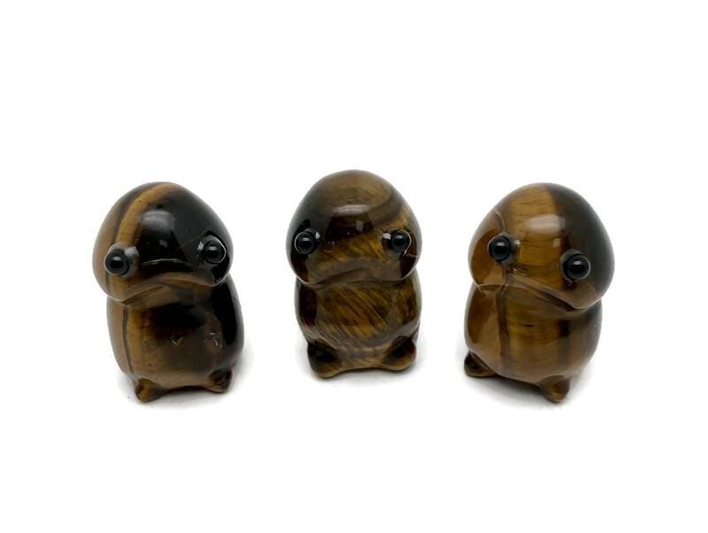 Handcrafted tiger eye frog gemstone carving, detailed creature statue with natural stone textures and vibrant earthy tones.