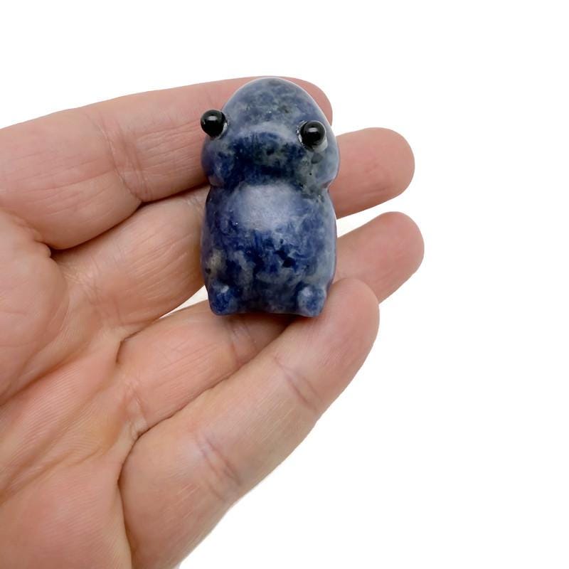 Handcrafted sodalite frog monster gemstone carving with detailed features and vibrant blue and white stone patterns.