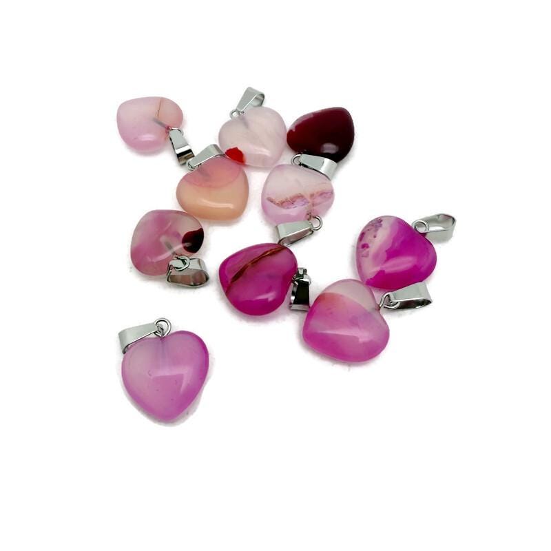 Pink agate heart pendant by GemstoneGO featuring a mini crystal design, showcasing a polished pink gemstone heart.