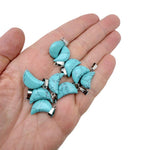 Turquoise Moon synthetic pendant from GemstoneGO for jewelry making, featuring a round turquoise-colored moon-shaped design.