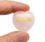 Rose Quartz heart engraved crystal by GemstoneGO showing a polished pink gemstone with engraved symbols representing love and peace.