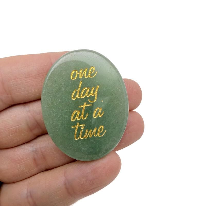 Engraved crystal with inspirational message "One Day at a Time" by GemstoneGO, featuring clear, polished gemstone with engraved text.