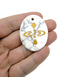 Drilled crystal amulet engraved with cosmic energy symbol, representing universe alignment, by GemstoneGO.