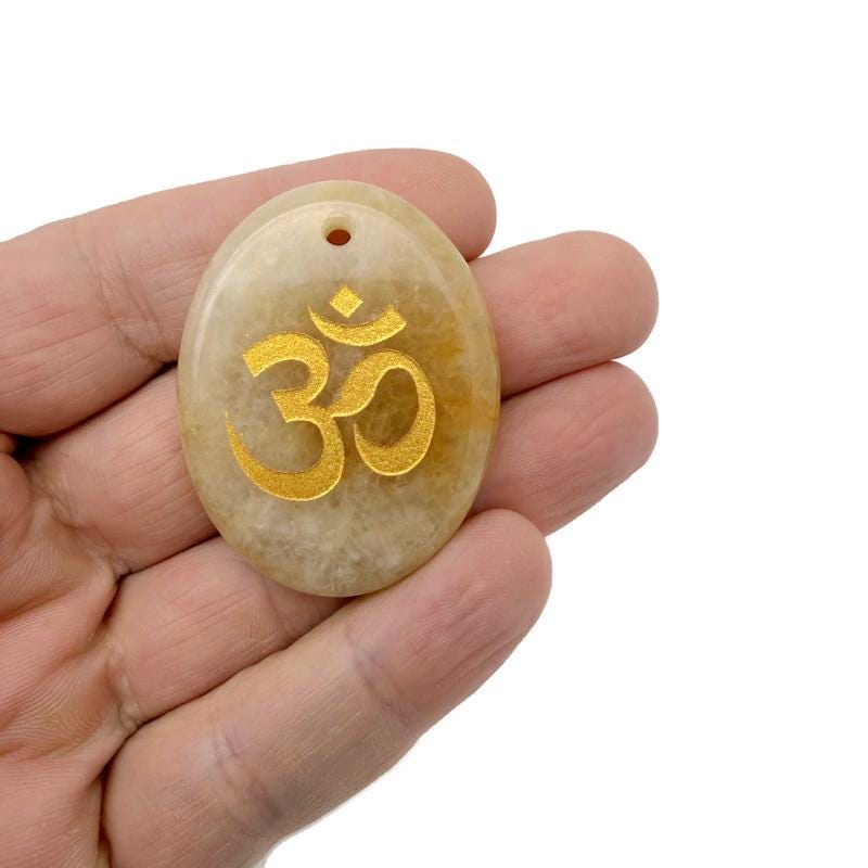 Drilled crystal pendant engraved with Om symbol, gemstone with spiritual Om symbol design for insight and guidance by GemstoneGO