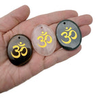 Crystal pendant with engraved Om symbol, drilled for jewelry, representing spiritual insight and guidance in a clear, polished design.