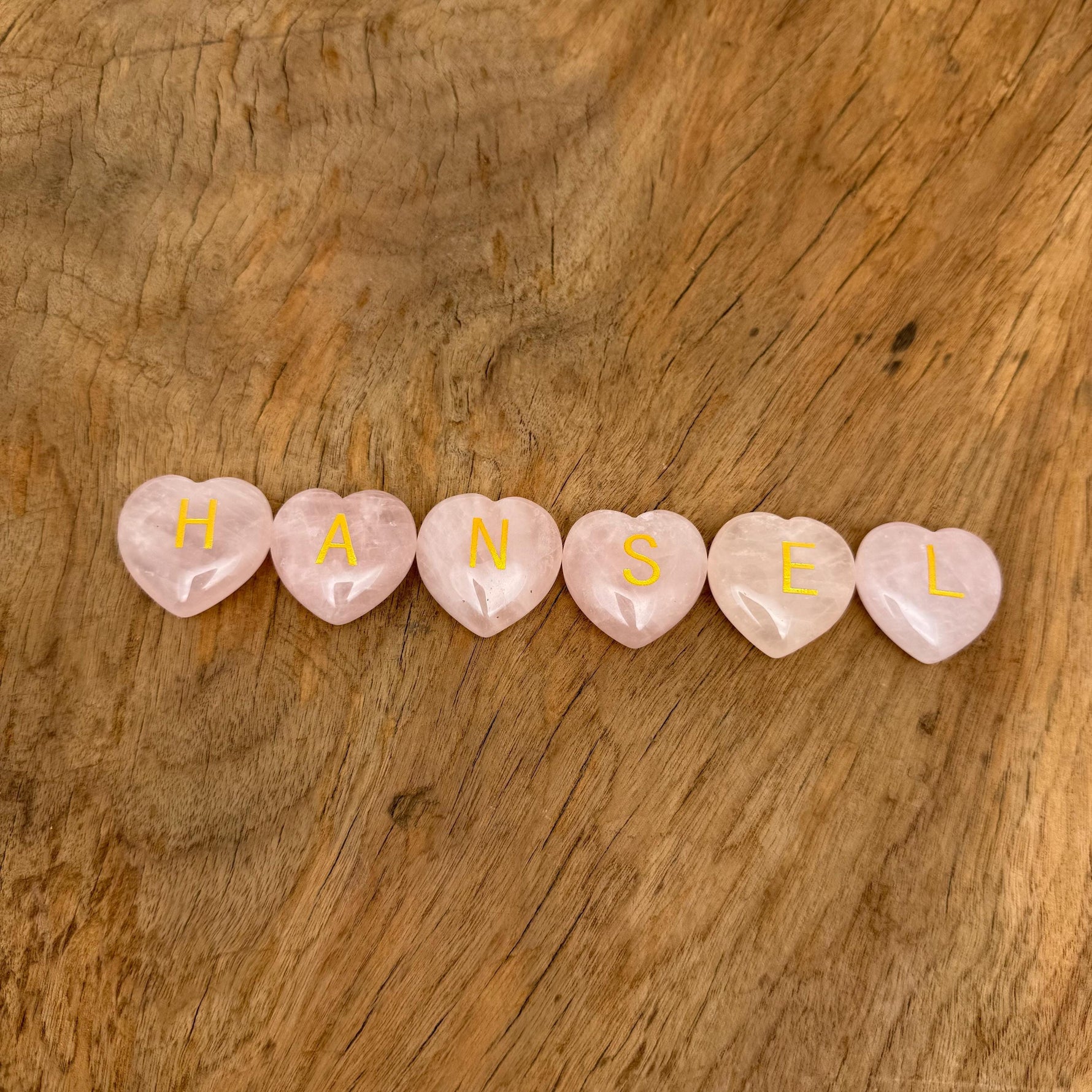 Rose quartz engraved crystal letter heart with personalized initial, crafted by GemstoneGO, featuring a polished crystal heart with engraved initial.