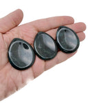 Moss agate worry stone from GemstoneGO, 45mm smooth crystal with green moss-like patterns, used for calming and meditation.