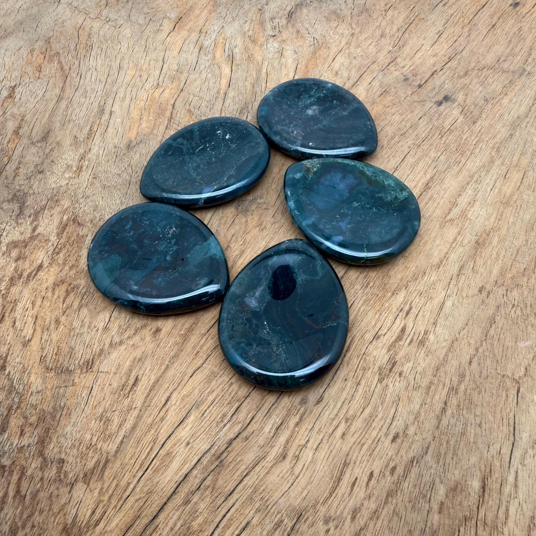 Moss agate worry stone from GemstoneGO, 45mm smooth polished crystal with natural green and brown moss-like patterns for calming use.