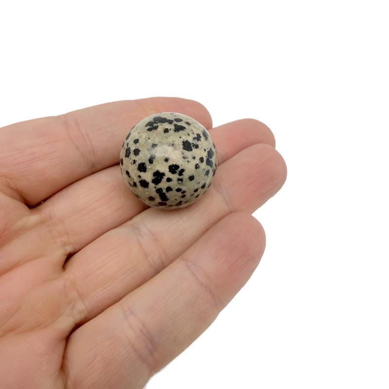 25mm natural crystal sphere from GemstoneGO, showcasing a clear, polished gemstone ball on a plain background.