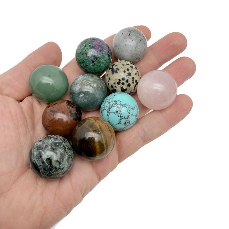 25mm natural crystal sphere from GemstoneGO, showcasing a clear, polished gemstone globe with a smooth, reflective surface.