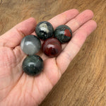 African Bloodstone sphere, 25mm crystal ball from GemstoneGO, showcasing deep green stone with red bloodstone inclusions.