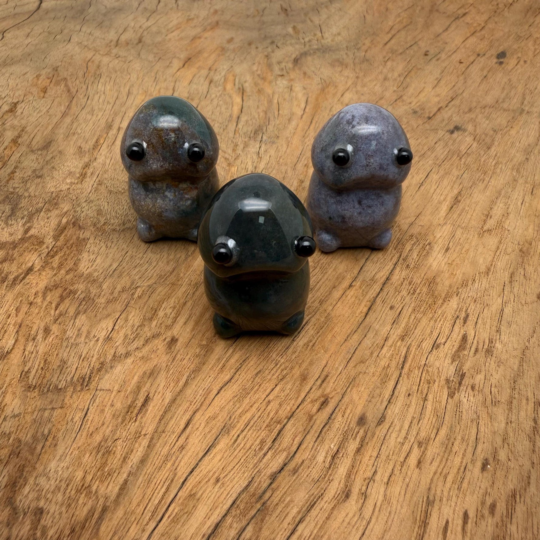 Handcrafted moss agate frog gemstone carving sculpture with detailed features, showcasing natural green and brown stone patterns.