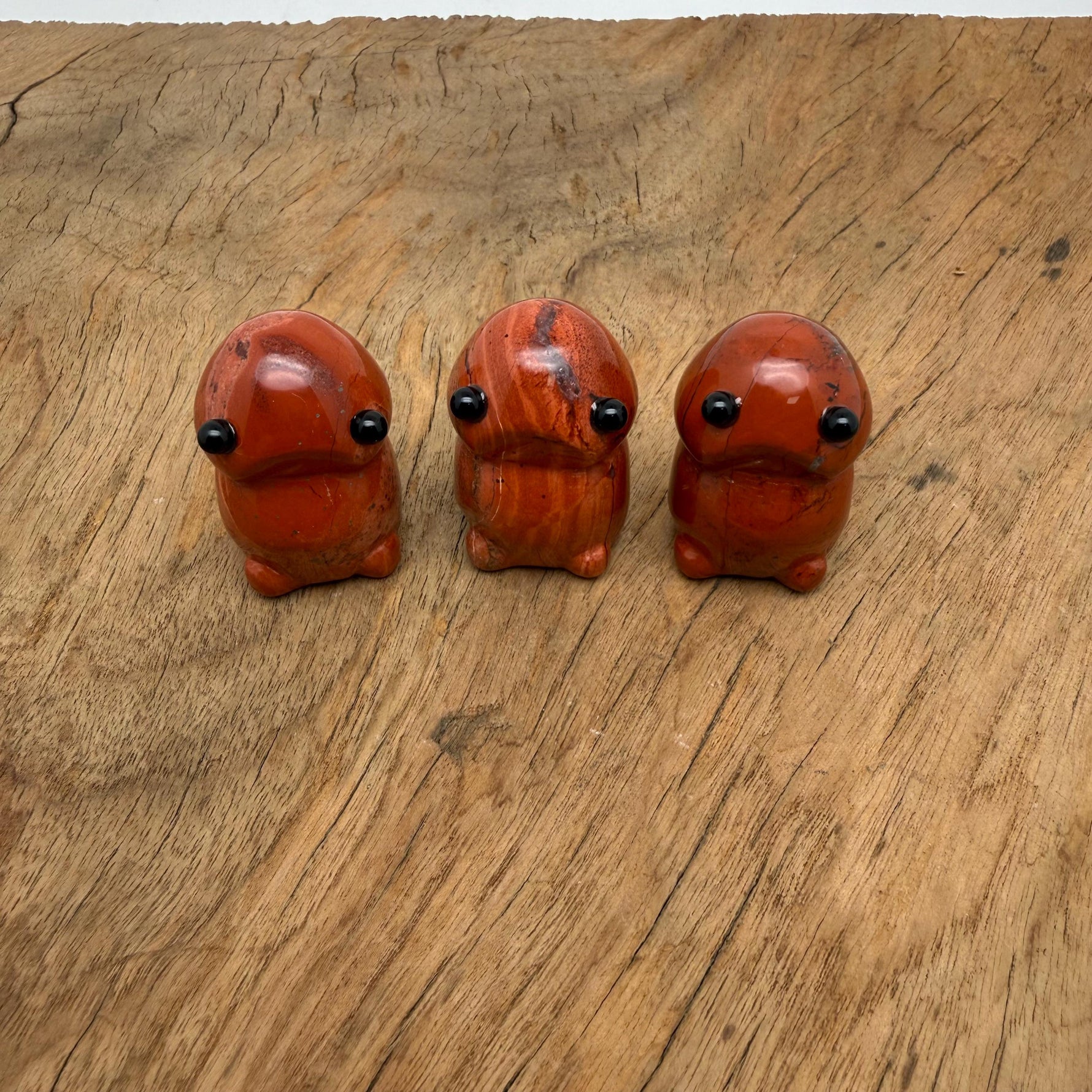 Red Jasper frog monster crystal carving by GemstoneGO, handcrafted gemstone creature statue with detailed features and vibrant red color.