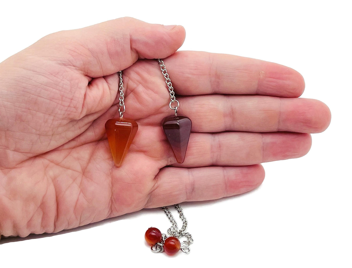 Healing crystal pendulum with stainless steel chain from GemstoneGO, featuring a polished gemstone and intricate metal detailing.
