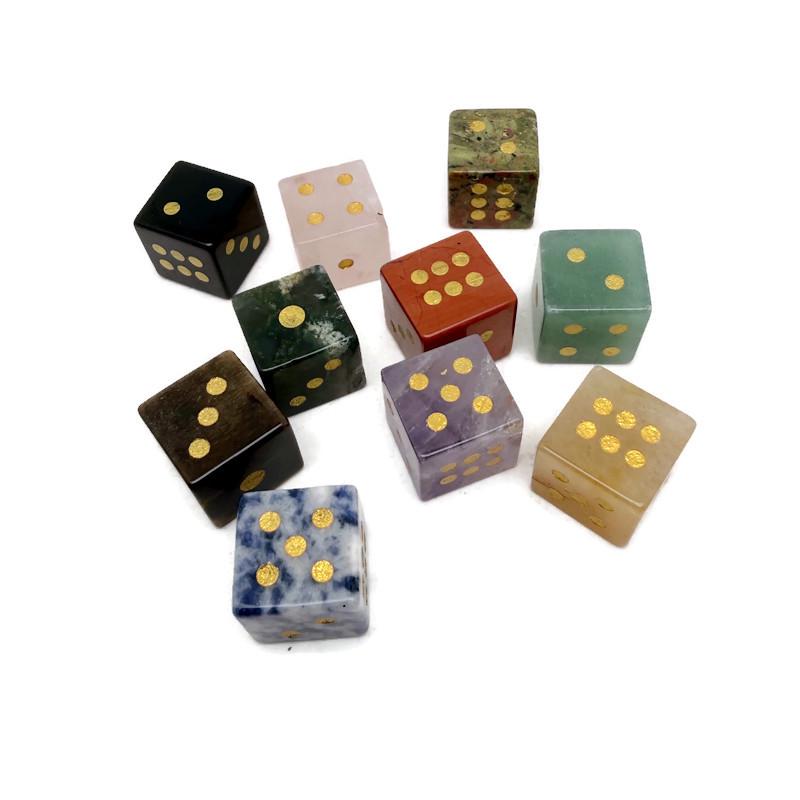 Polished gemstone crystal dice set by GemstoneGO featuring carved, colorful dice for metaphysical use and gaming.