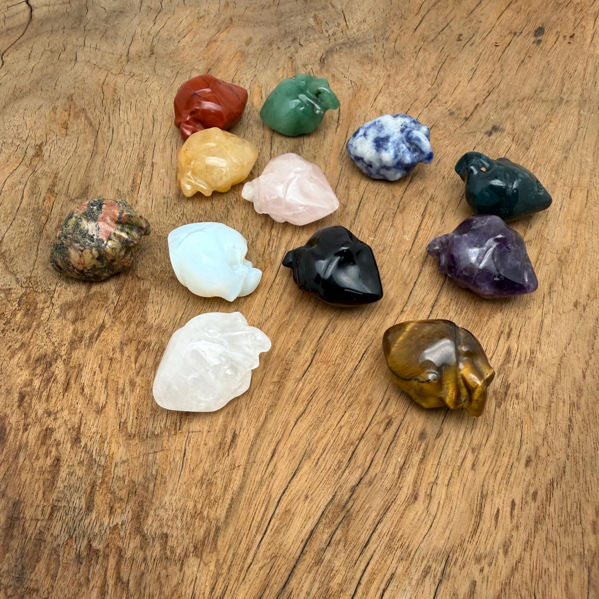 Handmade 30mm gemstone heart figure carving by GemstoneGO, featuring colorful crystal details on a clear background.
