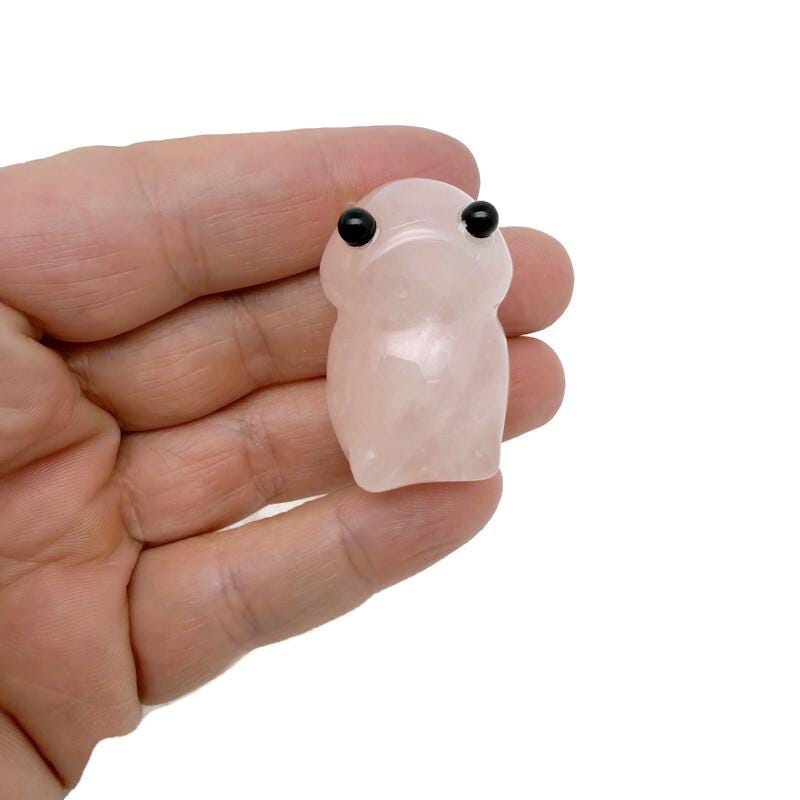 Handcrafted rose quartz frog monster gemstone carving, detailed creature statue with smooth polished surface and natural pink hue.